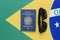 Top view of Brazilian passport and sunglasses on Brazilian flag in the background. Travel concept. Immigration and emigration,