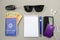 Top view of brazilian work card, banknotes, key, sunglasses, pen, credit card, ear phone and cell phone on white background.