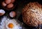 Top view on bread and eggs. Flour is scattered nearby, in the center lies the yolk. Cooking breakfast