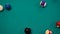 Top view: breaking racked colorful pool balls on teal billiard table - close up