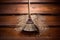 top view of a broom sweeping wooden floor with dust