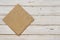 Top view of brown kitchen napkin on wooden planks background