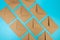 Top view of brown kraft envelopes on blue background.