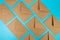 Top view of brown kraft envelopes on blue background.