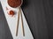 Top view on brown rice with chopsticks and saffron on wooden background