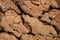 top view of brown stone coastline surface with cracks and erosion textures