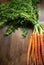 Top view of bunch of carrots on dark wooden background