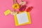 top view of bunch of colorful Gerbera flowers with blank paper on pink, mothers day concept