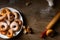 Top view on a bunch of fresh homemade donuts (doughnuts) on a white plate, with sugar bowl, rolling pin