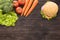 Top view burger and vegetables on the wooden background.