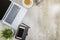 Top view of business desk with laptop, mobile phone, coffee, potted plant, notebook and business accessories