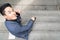 Top view of business man uses hand a smartphone and sits at stair pedestrian