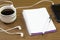 Top view business office desk.notebook,pencil,black coffee,tree,mobile phone,paperclips on wooden table background.