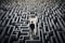Top view businessman in the middle of a big maze looking for a way out