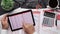 Top view of businessman working with financial statements. Modern black office desk with notebook, pencil and a lot of things.