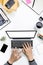 Top view businessman working with modern workplace with laptop on white table, Man hand on laptop keyboard with blank screen