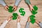 Top view of businesspeople holding dollar signs at wooden table