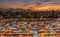 Top view of busy Asian street food at railway night market in Thailand with colorful stall and light at night time.