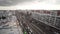 Top view of busy street of gray city. Action. Avenue with car traffic in city on cloudy day. City street with roadway on
