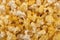 Top view on buttered popcorn texture as background.