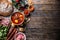 Top of view at cabbage soup - Kapustnica and ingredients for its preparation: Sauerkraut, sausage, smoked neck and knee, potatoes