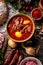 Top of view at cabbage soup - Kapustnica and ingredients for its preparation: Sauerkraut, sausage, smoked neck and knee, potatoes