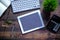 Top view of calculator digital tablet, tea and notepad on office table