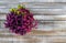 Top view on Calluna vulgaris, heath flower in rustic wicker planter on wood desk