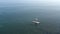 Top view. Calm seascape. In clear water floats lone surfer on sup board.