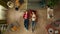 Top view capturing a young couple laying on the floor next to each other, talking to each other and laughing, pointing