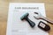 Top view of car insurance with car remote key, wrench and rubber