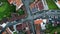 Top view cars riding asphalt road at green valley countryside. Rural houses roof