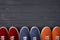 Top view of casual colorful suede trainers on grey wooden planks