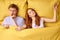 top view on caucasian couple lying on bed, woman disturbing man to sleep, at night