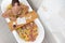 Top view of caucasian female in swimsuit sitting in bathtub with fresh slices of tropical fruits.