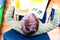 Top view Caucasian nine years old schoolboy reading a book, learning exercise books