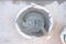 Top view cement liquid stirred with trowel in old bucket ready to plaster . Manual work tool for construction