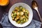 Top view of a ceramic bowl with roasted brussel sprouts on a table.