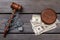 Top view chained gavel and dollars.