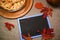 Top view chalkboard with copy space, next to autumn maple leaves and homemade Thanksgiving pumpkin pie with crispy crust