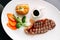 Top view of Charcoal grilled boneless dry-aged Top Loin steak served with BBQ sauce, stir-fried vegetables and baked potato.