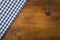 Top view of checkered kitchen towels on wooden table