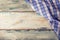 Top view of checkered napkin on wooden table