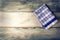 Top view of checkered napkin on wooden table