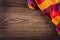 Top view of checkered napkin on wooden table