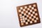 Top view of checkers on wooden checkerboard