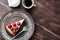 Top view cheesecake with raspberries, cup of coffee and cream on wood