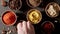 TOP VIEW: Chef takes a spices in variety of colourful seasoning on a table