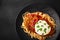 Top view chicken parmigiano with linguini pasta in plate