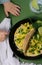 top view of child hands grabbing tortilla breakfast with scrambled eggs, avocado and cheese